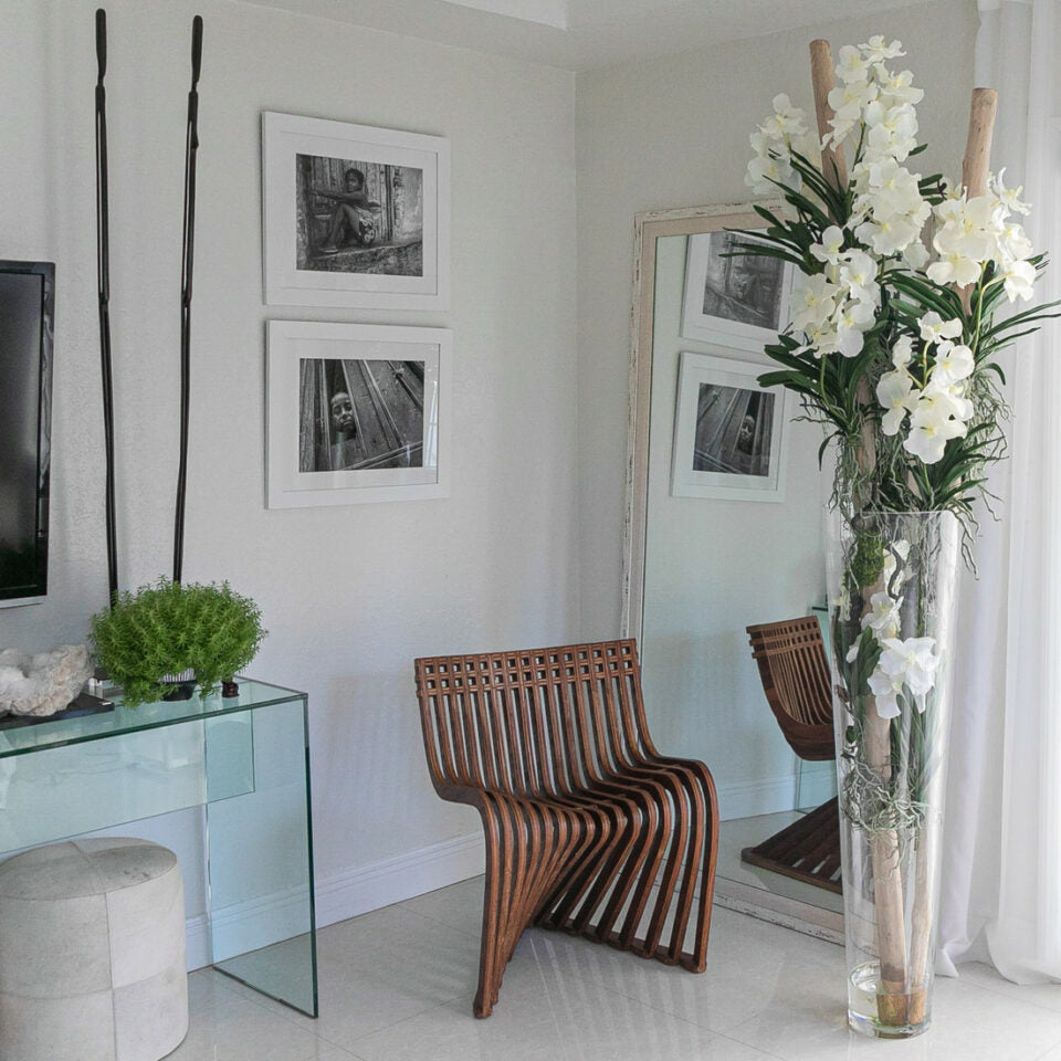 White Vanda Orchids and Driftwood Inside a Large Conical Glass Cylinder